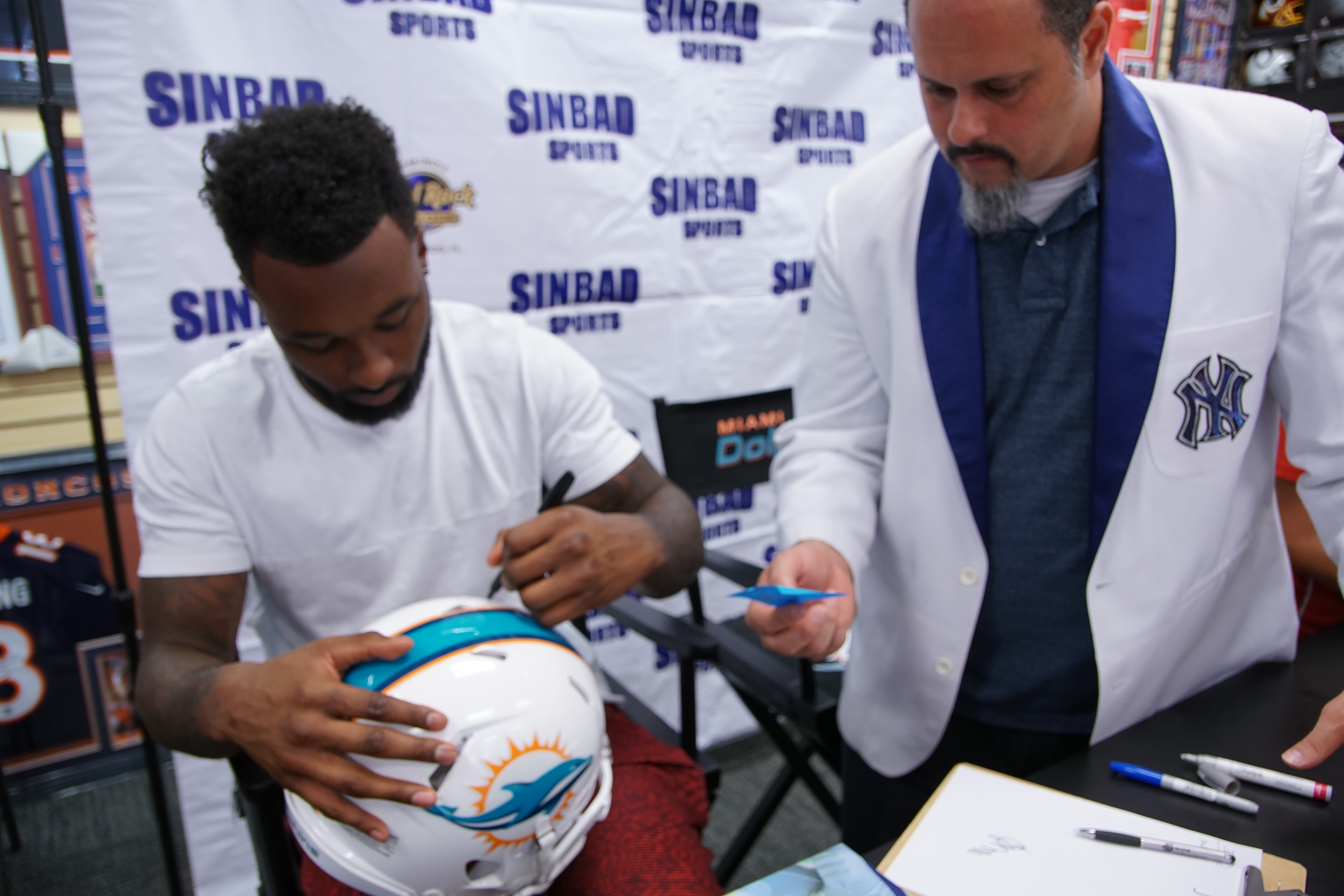 jarvis landry signing helmet for a fan at sinbad sports